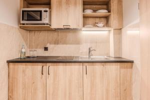 a kitchen with a sink and a microwave at Apartment-Hotel Hamburg Mitte in Hamburg