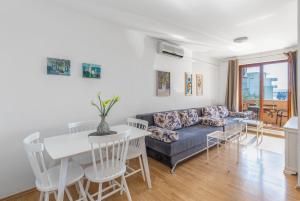 a living room with a couch and a table at Sweet Escape in Makarska +15 photos