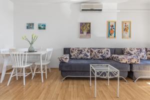 a living room with a couch and a table at Sweet Escape in Makarska
