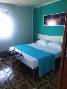 a bedroom with a bed with a blue wall at B&b La Vigna in Furore +22 photos