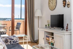 a living room with a flat screen tv on a cabinet at Sweet Escape in Makarska