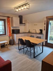 a kitchen and dining room with a table and chairs at Villa Clara in La-Roche-en-Ardenne