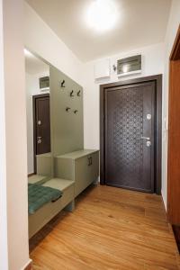a room with a door and a wooden floor at MaxInn 14 in Pirot