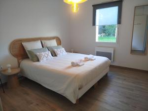 a bedroom with a bed with two stuffed animals on it at Chambres d'hôtes" Tout Simplement" in Beaurepaire +1 photo