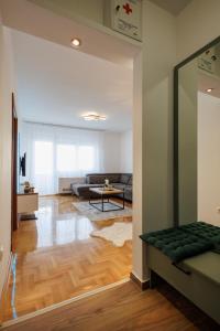 a living room with a couch and a table at MaxInn 14 in Pirot