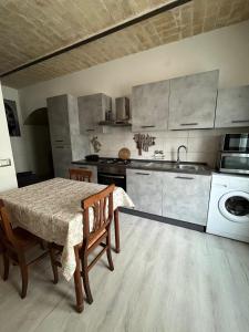 a kitchen with a table and a sink and a stove at Casa CAMILLA in Vasto
