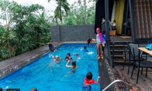 a group of children playing in a swimming pool at Villa Nelith in Galle