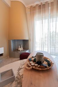 a room with a table with a cake on top of it at Aeris Apartment by Booking Kottas in Nea Moudania +26 photos