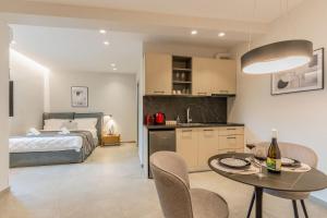 a kitchen and a bedroom with a bed and a table at K35 Apartments in Preveza