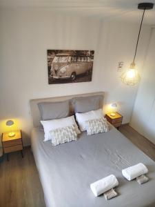a bedroom with a large bed with two white pillows at Chambres d'hôtes" Tout Simplement" in Beaurepaire