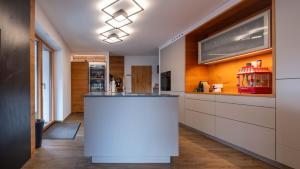 a kitchen with a white island in the middle at Relax Walding in Jörgensbühl