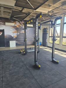 a gym with several poles in a building at Cozy Moov Smart Apartamento in Cuiabá