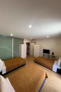 a bedroom with two beds and a table and a chair at Casa Augusta 4 in Braga