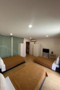 a bedroom with two beds and a flat screen tv at Casa Augusta 4 in Braga +49 photos