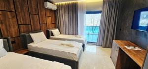 a hotel room with two beds and a television at Hotel Diamant in Tropojë +34 photos