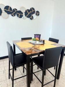 a dining room table with chairs and a plate on it at Charming 3BR Near Ponce Attractions in Ponce