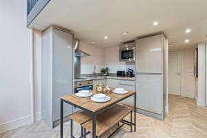 a kitchen with a wooden table with plates on it at Urban Luxe Loft Hideaway in Central Station