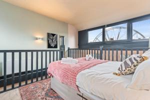 a bedroom with a bed and a large window at Urban Luxe Loft Hideaway in Central Station