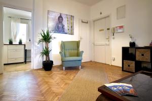 ウィーンにあるOPERASTREET CITY CENTER Apartment "Bangkok" in Viennaのリビングルーム(椅子、テーブル付)