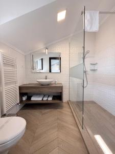 a white bathroom with a sink and a shower at White Residence in Arad +23 photos