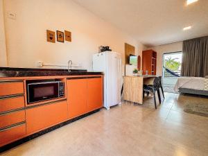 a kitchen with a refrigerator and a table in a room at Centro | Studio Completo até 4 pessoas in Brusque