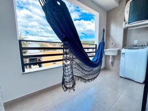 a bathroom with a hammock in a room with a window at Centro | Studio Completo até 4 pessoas in Brusque