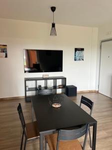 a dining room with a black table and chairs at Apartment Le Forge in Policoro