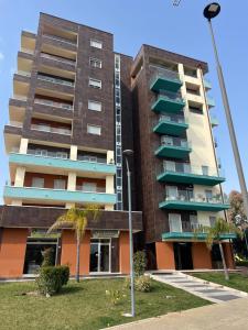 a tall apartment building with balconies and a street light at Apartment Le Forge in Policoro