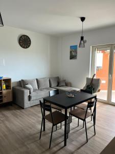 a living room with a table and a couch at Apartment Le Forge in Policoro