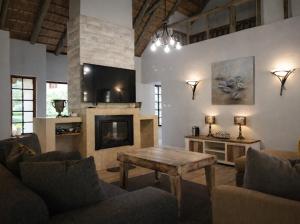 a living room with a table and a fireplace at Hilton Creek in Hilton