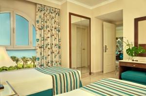 a hotel room with two beds and a window at Cardina Resort in Marsa Alam City +17 photos