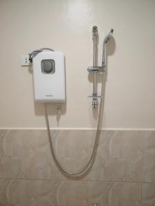 a shower in a bathroom with a hose at Natalie's Homestay Bed and Breakfast in El Nido +39 photos