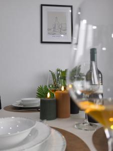 a table with a wine glass and a bottle of wine at The Günz Homes 2 in Günzburg +19 photos