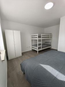 a bedroom with a bed and a white cabinet at The Günz Homes 2 in Günzburg
