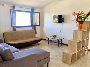 a living room with a couch and a table at Case Géranium 2* piscine chauffée in Saint-Joseph