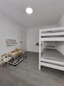 a bedroom with a bunk bed and a table and a desk at The Günz Homes 2 in Günzburg