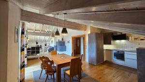 a kitchen and dining room with a table and chairs at Jungholz Erlebnis in Jungholz