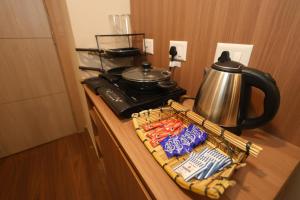 a basket of food sitting on a counter next to a kettle at Sunleaf Studio Pari Chawk Expo Mart in Greater Noida
