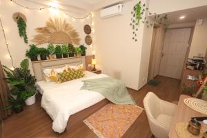 a bedroom with a bed with plants on the wall at Sunleaf Studio Pari Chawk Expo Mart in Greater Noida