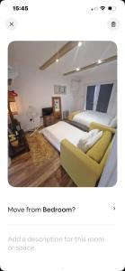 a bedroom with a bed and a couch at Lovely garden cabin in Luton