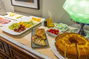 a table with a cake and various fruits and vegetables at Casa do Juncal in Guimarães +86 photos