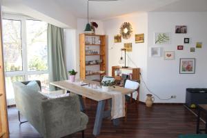 a dining room with a table and chairs at Appartement Erzgebirge in Schönheide +35 photos