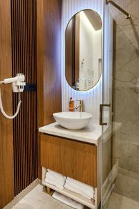 a bathroom with a sink and a mirror at Celeste Villa Boutique in Ranca +69 photos