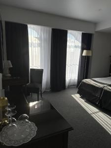 a hotel room with a bed and a desk at Optima Collection Bergshloss Rivne in Rivne
