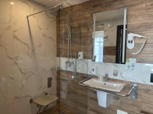 a bathroom with a sink and a shower and a mirror at Optima Collection Bergshloss Rivne in Rivne