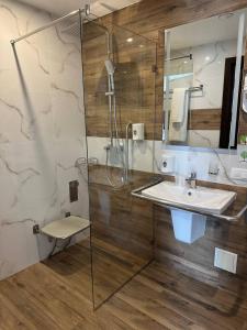 a bathroom with a glass shower and a sink at Optima Collection Bergshloss Rivne in Rivne +79 photos