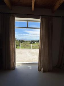 an open window with a view of a field at Firgrove Country Lodge in Robertson