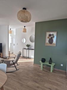 a living room with a chair and a table at le St fursy 31 in Péronne