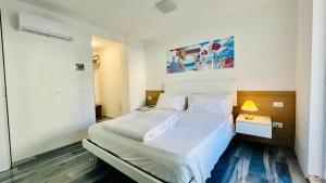 a bedroom with a large white bed in a room at I Bordin Home in Nettuno
