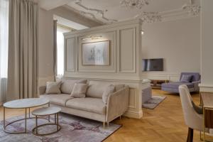 a living room with a couch and a table at Hotel Traugutta 12 in Łódź